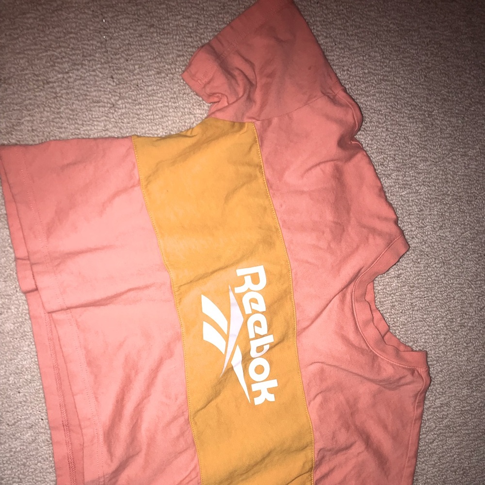 Adorable cropped Reebok top! Pairs cute with anything ! Peach and yellow. Med.